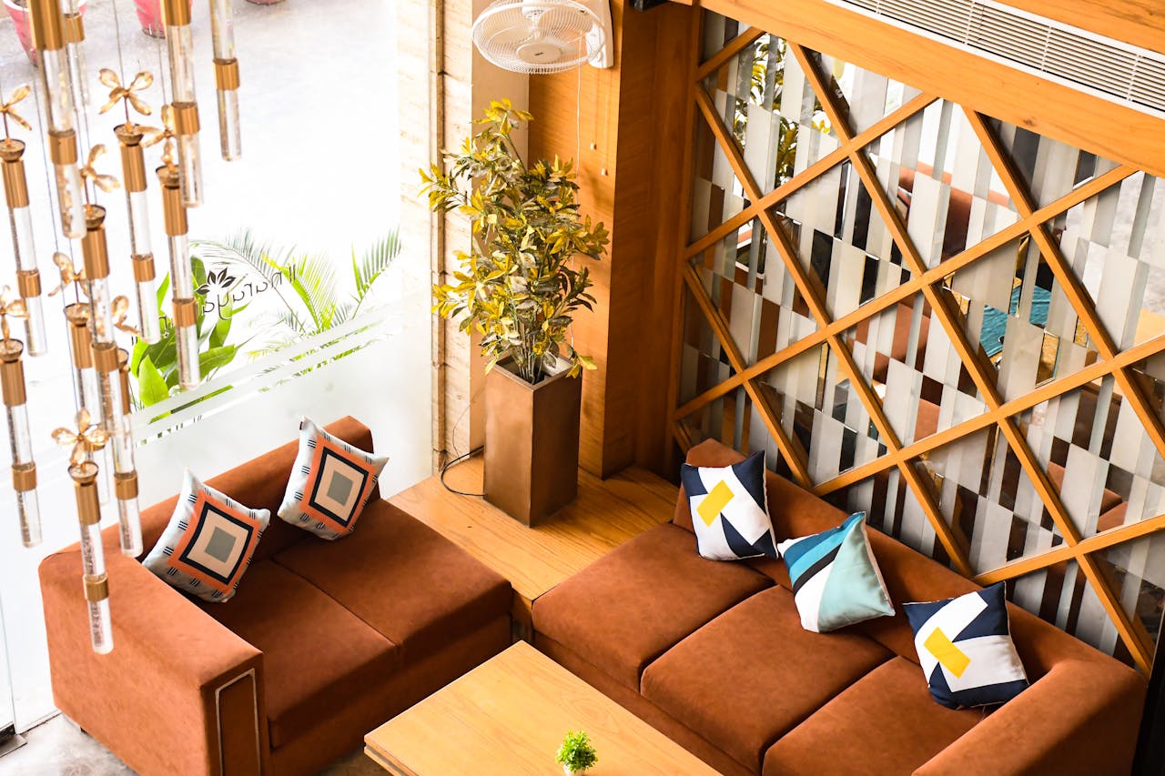 Stylish living room with brown sofas, decorative pillows, and modern decor in a cozy setting.