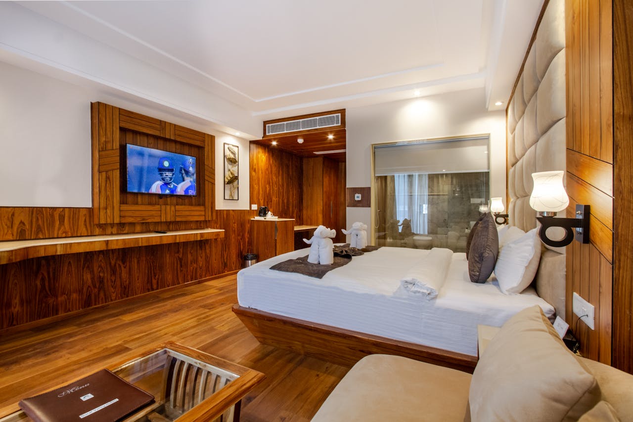 Luxurious modern hotel room with elegant furniture and flat-screen TV.